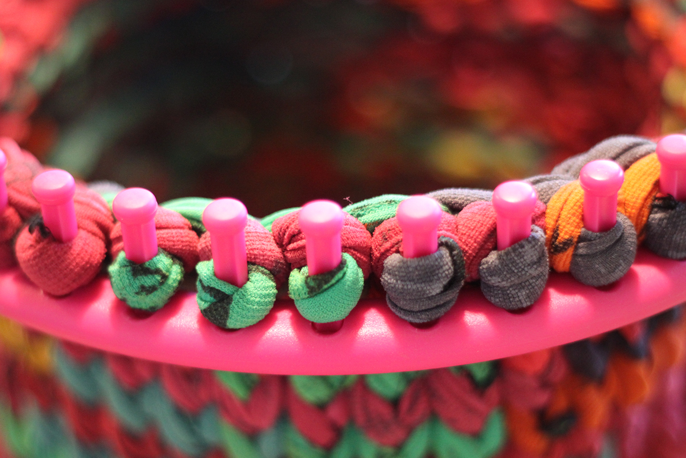 Detail photo of the round knitting loom with the work in progress.