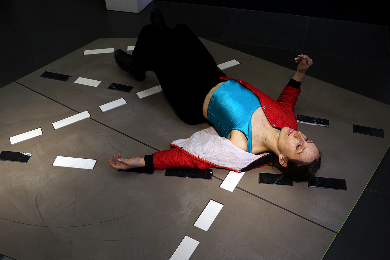 Roxanne Nesbitt lying on her installation in the hcma Vancouver office lobby.