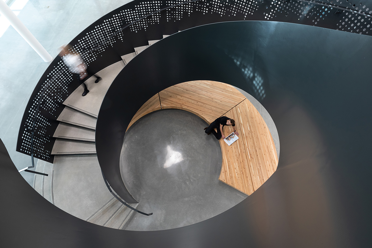 Looking down through the centre of the Clayton Community Centre spiral staircase with its perforated metal railing.