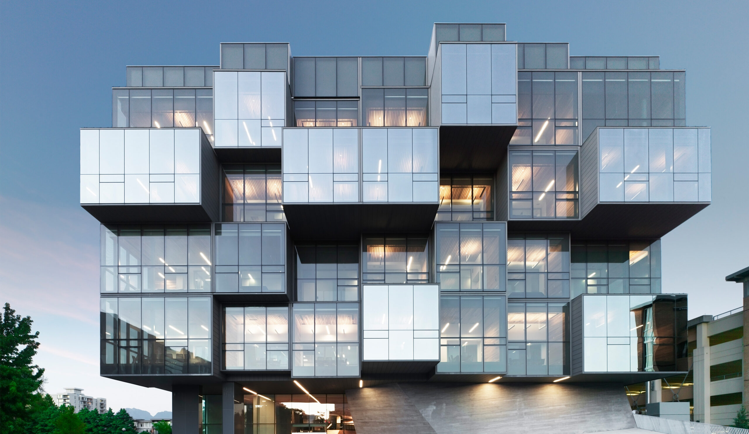 Glass building with multiple rooms protruding out.