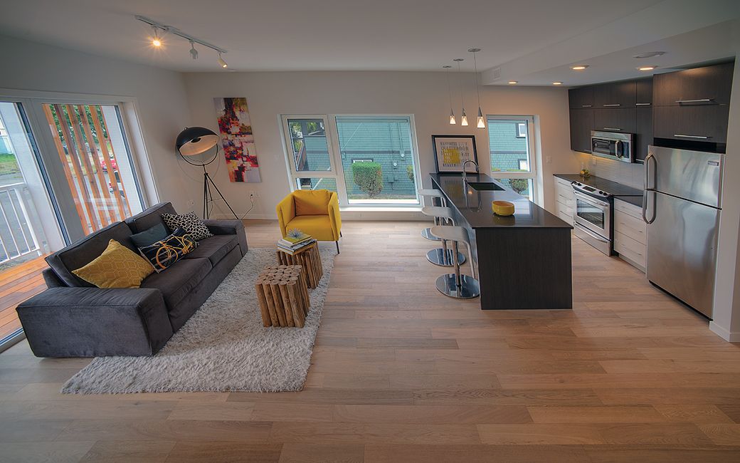 Interior of a house living room and kitchen with an open floor plan.