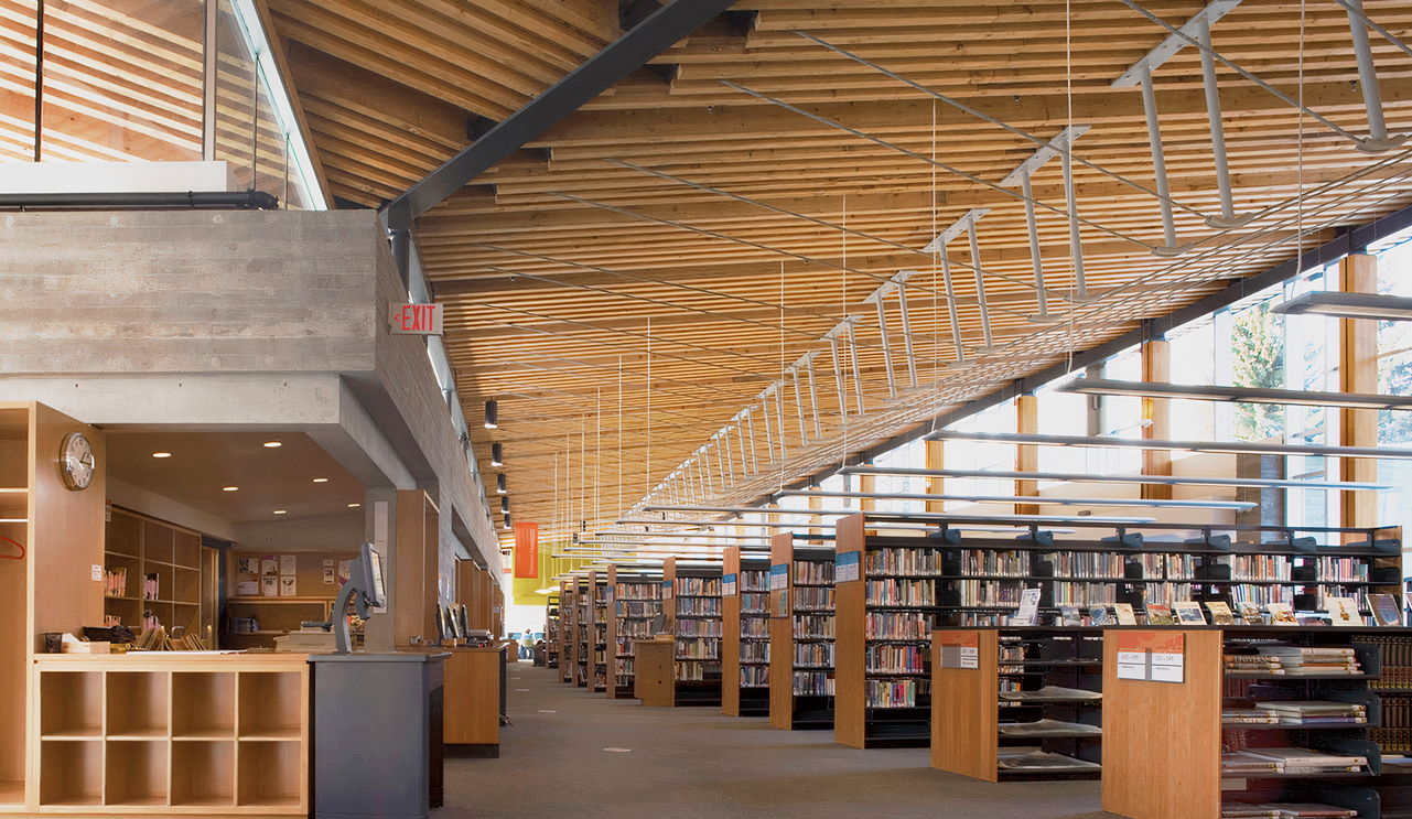 Interior shot of the Whistler Public Library front desk and book stacks.