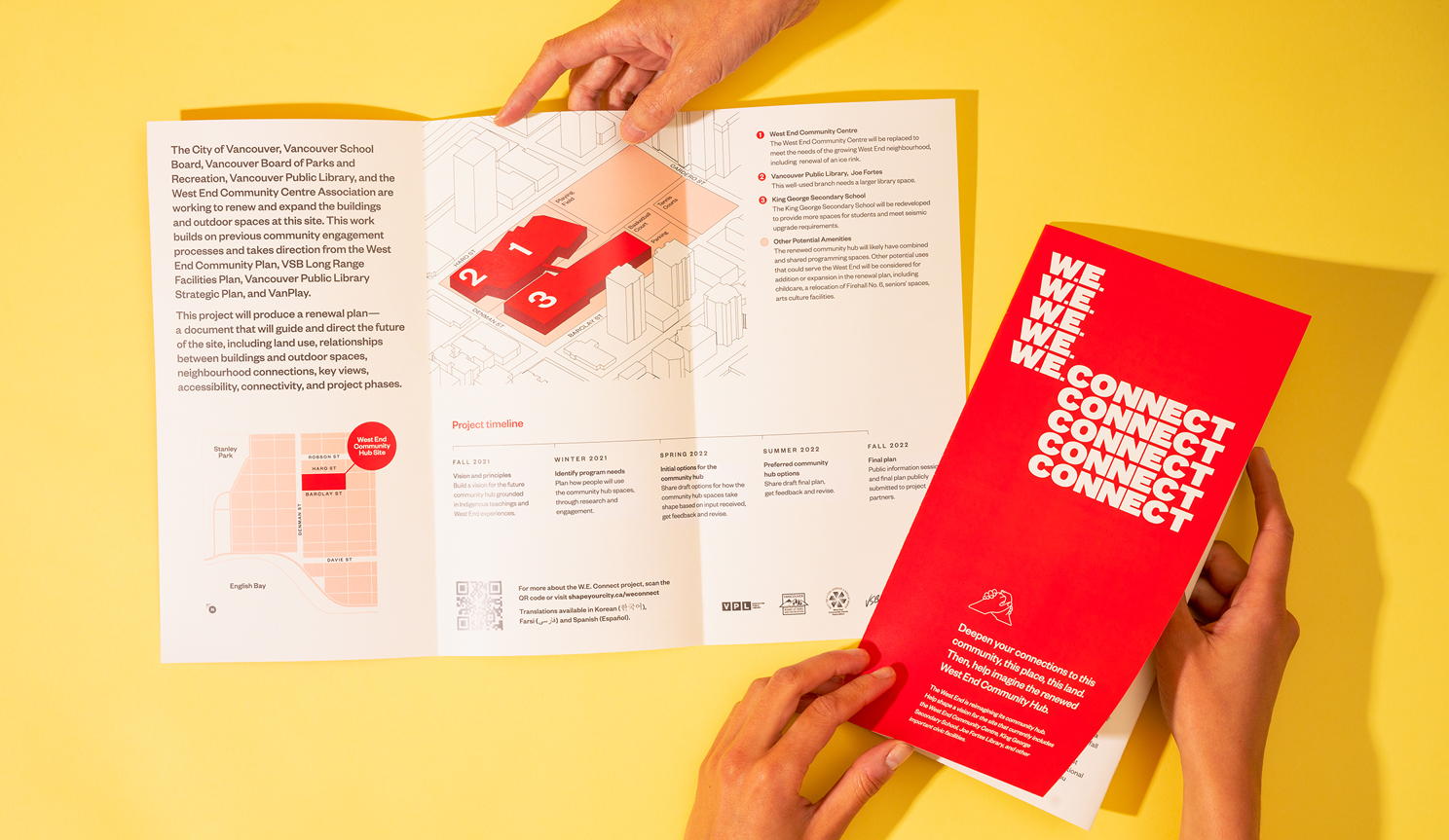 Hands opening a pamphlet that says "W.E. CONNECT" on it, shows project timeline and other graphics.
