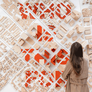 Wall-mounted exhibit with a woman standing close, looking at the details.